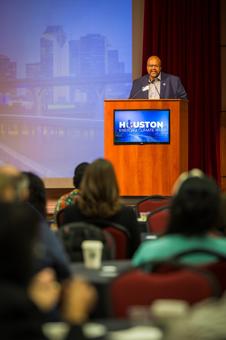 Speaker at HECW podium with audience