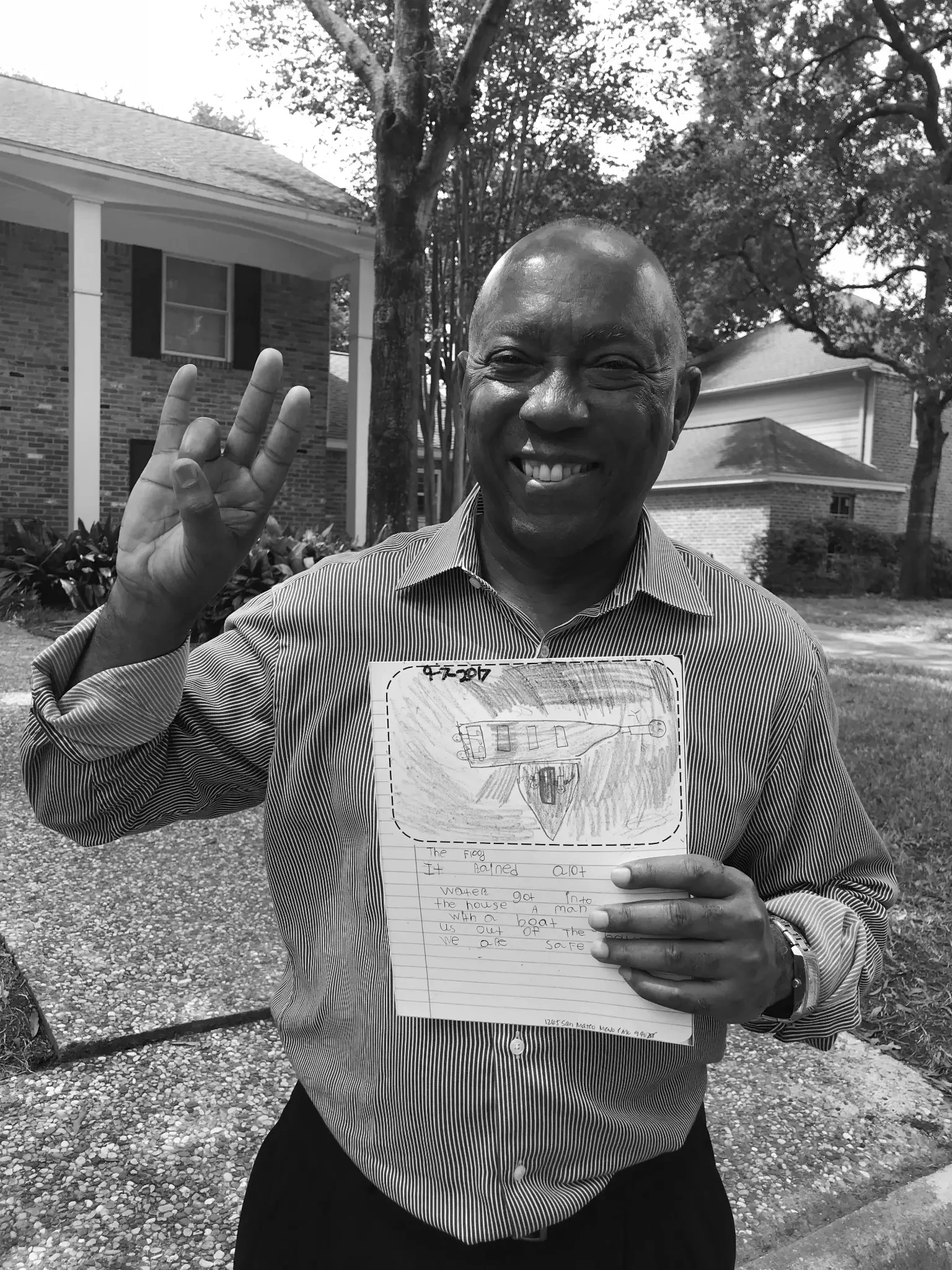 Mayor Turner holds a drawing by Katie's daughter — a boat rescuing her family during Harvey