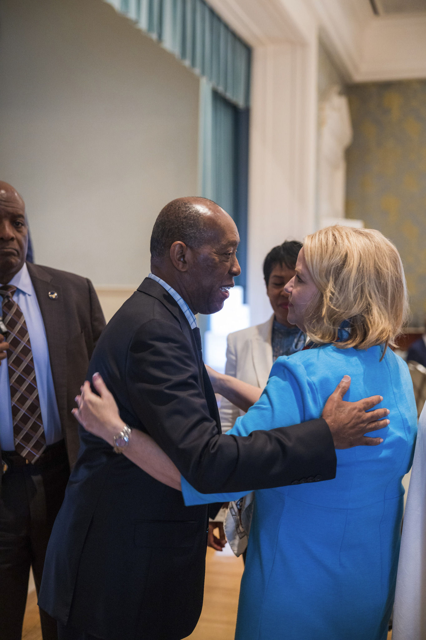 Mayor Sylvester Turner embraces Katie Mehnert at the GRIT Award luncheon, 2022
